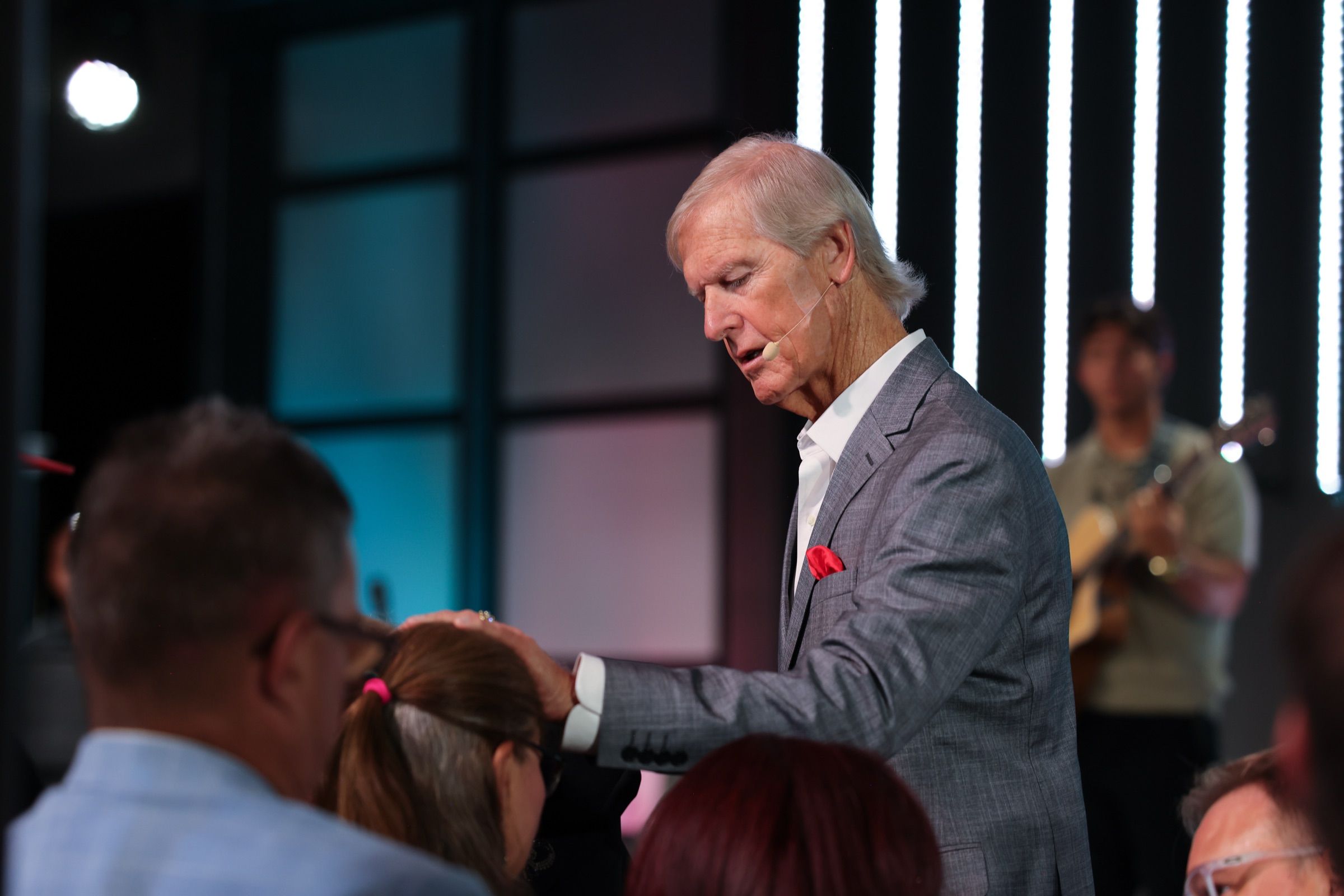 Apostle Theo Wolmarans laying a hand on a woman in prayer